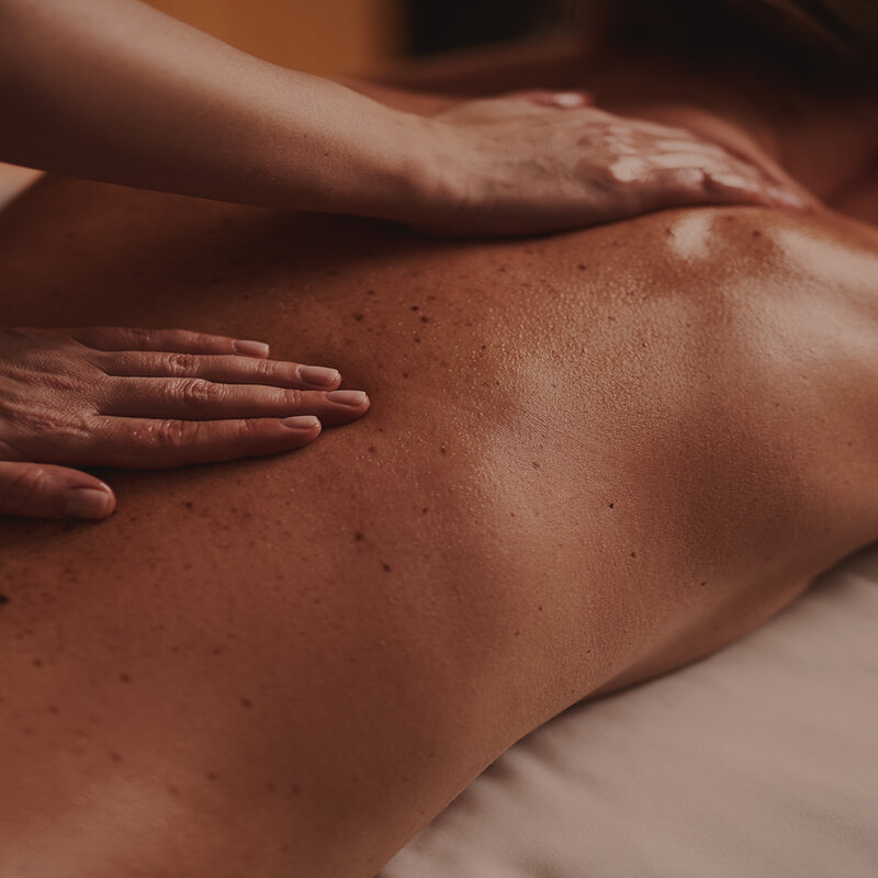 Person getting a hot stone massage.